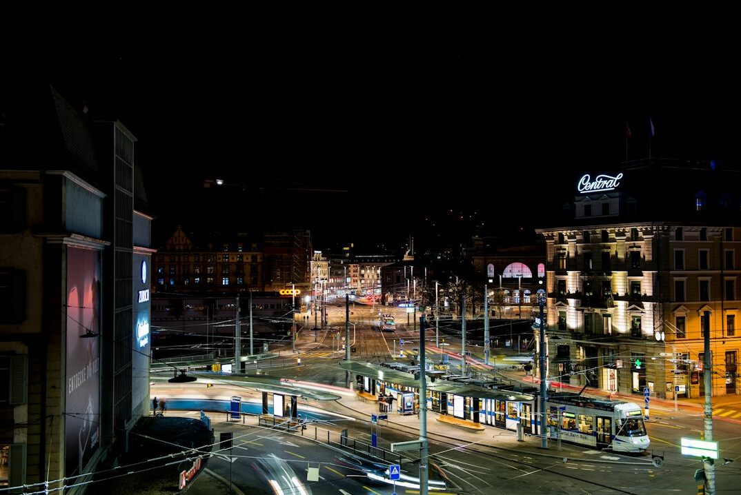 Zwei Freunde auf einer Rooftop-Bar in Zürich bei Nacht